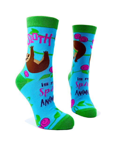 Bright blue women’s novelty crew socks with green cuff, heel, and toe featuring a cute sloth design and the phrase Sloth Is My Spirit Animal.