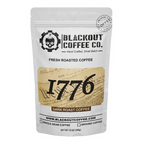 White coffee bag with Blackout Coffee Co. branding and '1776' dark roast coffee label.