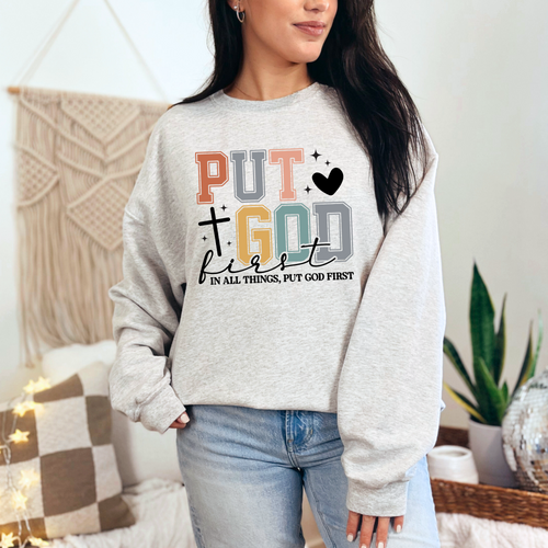 Person wearing a gray sweatshirt with motivational text in a home setting