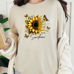 Natural graphic tee with gold sunflower design and “Be the Sunshine” inspirational message