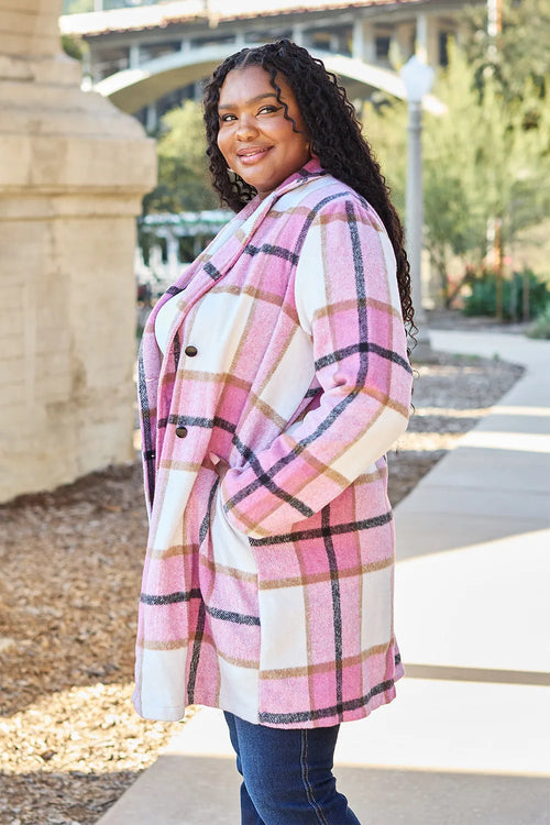Woman wearing a pink plaid coat outdoors