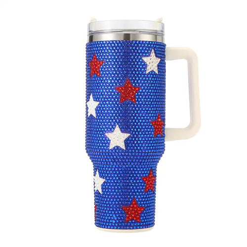 Blue rhinestone tumbler with red and white star accents, handle, and lid for patriotic summer drinkware