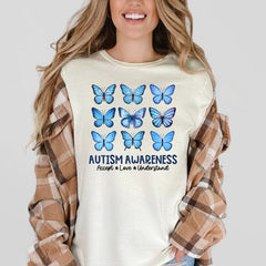 Graphic tee showing three rows of three blue butterflies with text below reading Autism Awareness Accept Love Understand.