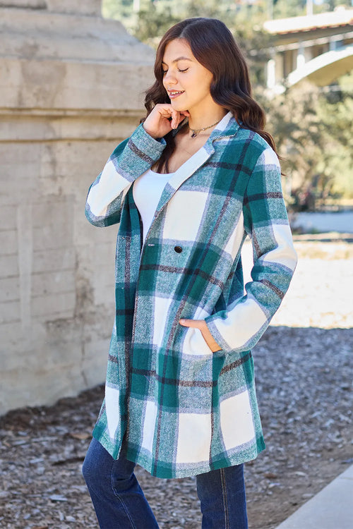 Woman wearing a plaid coat in an outdoor setting