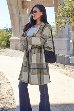 Woman wearing a plaid coat with a blurred background
