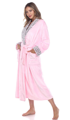 Woman wearing pink plush robe with leopard trim side view