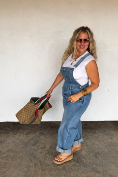 Back view of the Coast Overalls showing the crossover strap design and back pockets.