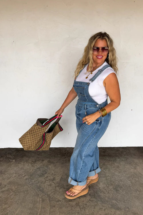 Back view of the Coast Overalls showing the crossover strap design and back pockets.