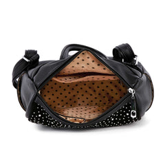 Top view of the inside of a rhinestone flag backpack showing polka dot lining and interior pockets.