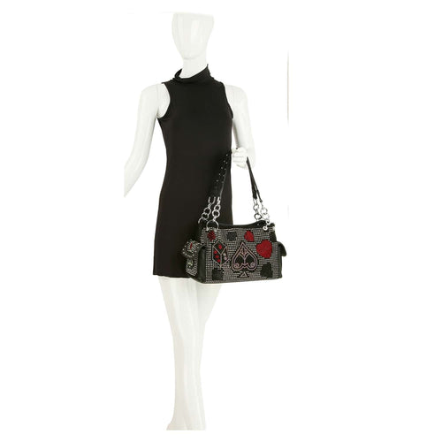 Mannequin wearing a black dress with a decorative handbag on a white background