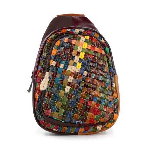 Multicolored woven bag with brown leather accents on a white background