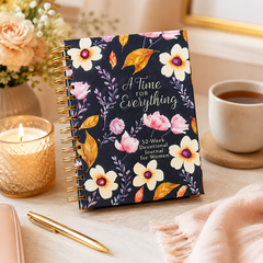 Floral notebook titled 'A Time for Everything' on a table with a cup of coffee, candle, and pen.