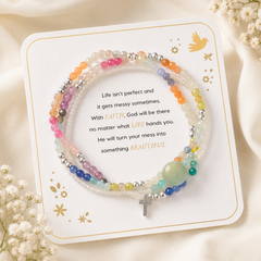 Messy Life Charm Bracelet displayed on its sentiment card with multicolor beads, silver accents, and a small cross charm on a soft ivory background with delicate flowers.