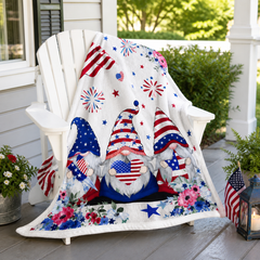 Patriotic gnome blanket displayed on a white porch chair with small American flags and festive outdoor decor.