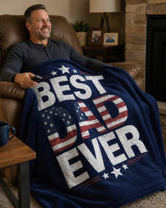 Dad sitting in a cozy living room recliner with the Best Dad Ever navy patriotic flannel blanket across his lap.