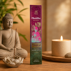 A box of Buddha Blessing Magical Sparkle Incense Sticks stands on a wooden surface between a seated Buddha statue and a lit candle, with warm ambient lighting and soft background decor.