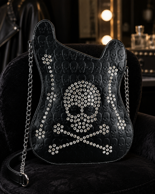 Black quilted handbag with skull design and chain strap on a dark background
