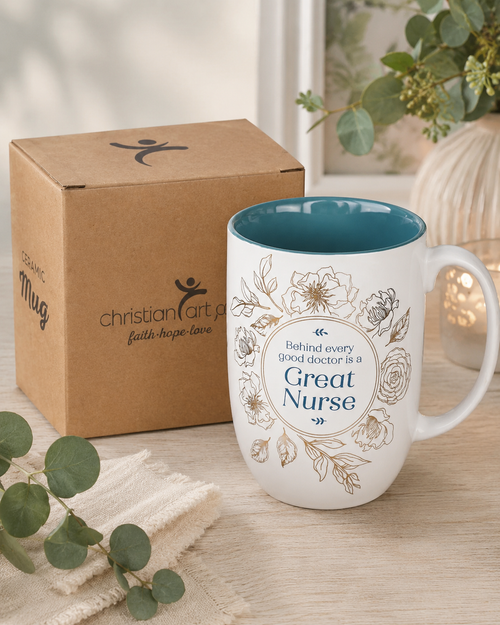 Great Nurse teal floral ceramic mug displayed beside its Christian Art Gifts kraft box packaging.