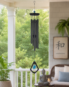 Natural blue agate wind chime hanging near a quiet patio or meditation space.