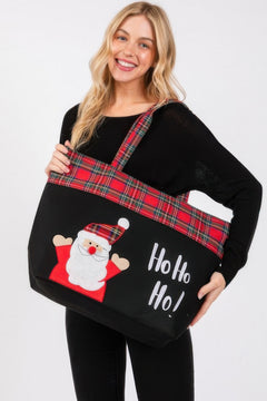 Woman holding a black tote bag with Santa Claus design and 'Ho Ho Ho!' text on a white background