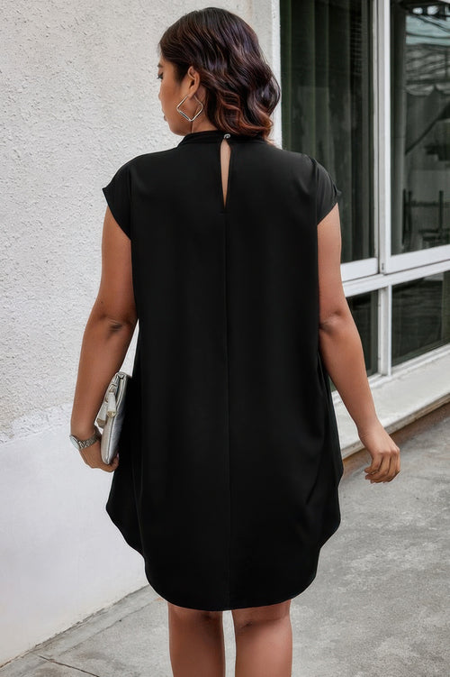 Woman wearing a black plus size blouse walking outdoors.