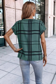 Back view of green plaid blouse showing relaxed fit and rounded hemline.