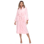 Woman in pink plush robe with tie belt and pockets