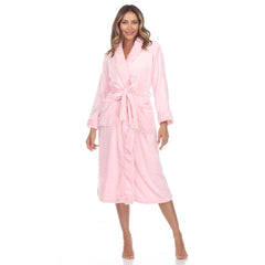 Woman in pink plush robe with tie belt and pockets