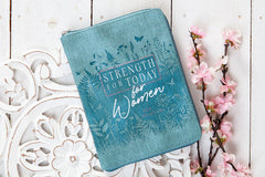 Blue pouch with 'Strength for Today for Women' text on a decorative white surface with flowers.