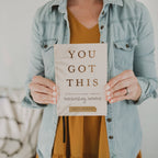 Woman holding the You Got This 90-day devotional for hardworking women