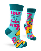 Bright teal women’s novelty crew socks with dark teal cuff, heel, and toe featuring the phrase Love Yourself You Badass Bitch with pink, yellow, and floral-inspired accents.