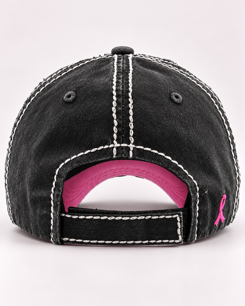 Back view of distressed black pink ribbon baseball cap with adjustable closure