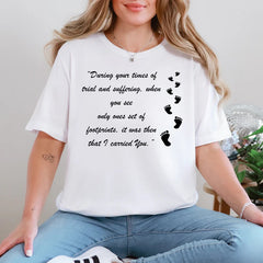 Person wearing a white t-shirt with a motivational quote and footprints design.