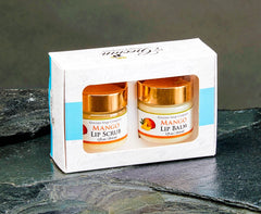 Set of Mango Lip Scrub and Lip Balm in a branded box on a dark surface.