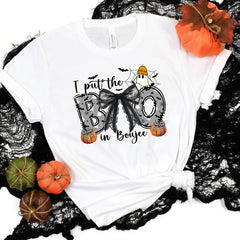Boo in Boujee graphic tee in white, flat lay with mini pumpkins and black lace.