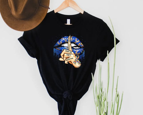 Black graphic tee featuring blue puzzle-patterned lips and a hand with the text Don't Judge What You Don't Understand.