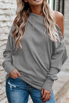 Chic single shoulder long sleeve sweatshirt in gray with zipper detail, shown on model styled with jeans. Trendy women’s pullover for casual wear.