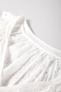 Close-up of the V-neckline and intricate eyelet design.