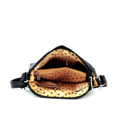 Open handbag with black interior and gold exterior on a white background