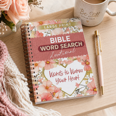 Bible Word Search devotional book with floral design on a wooden surface with a mug and pen.