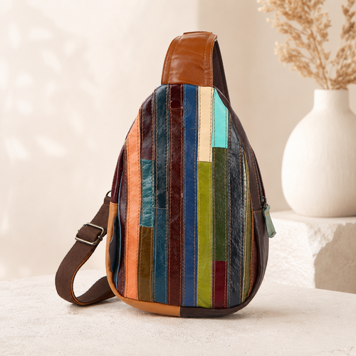 Multicolored striped sling bag on a light surface with a neutral background