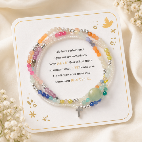 Messy Life Charm Bracelet displayed on its sentiment card with multicolor beads, silver accents, and a small cross charm on a soft ivory background with delicate flowers.