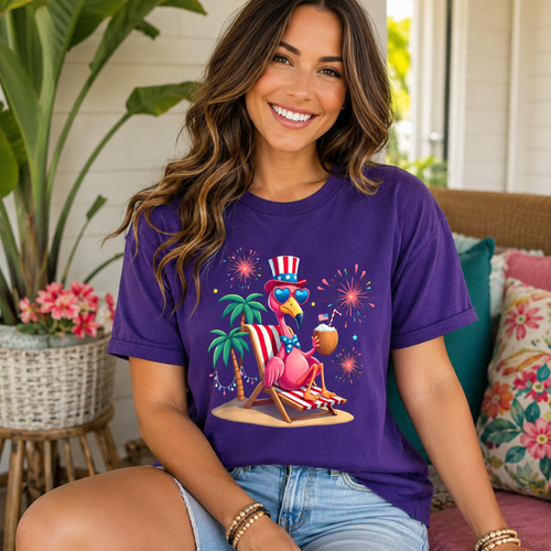 Purple Beach Flamingo Graphic Tee with playful patriotic flamingo graphic and fireworks on model.