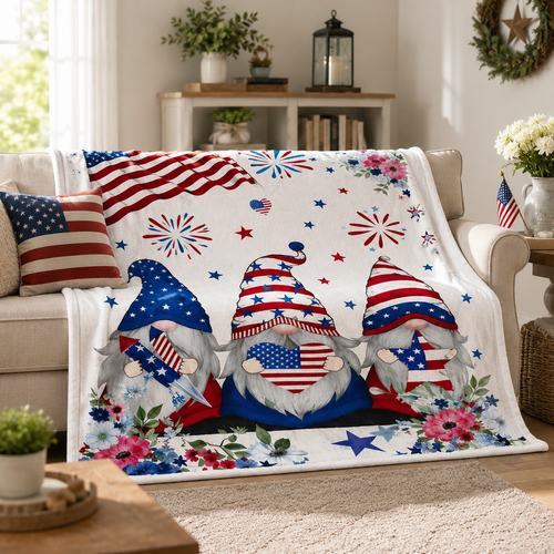 Patriotic gnome blanket draped over a beige couch in a cozy living room with Americana decor and red white and blue accents.