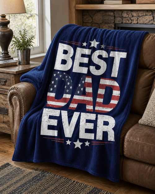 Best Dad Ever navy patriotic flannel blanket styled over a brown living room recliner in a cozy home setting.