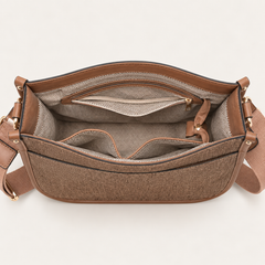 Open brown denim crossbody bag showing organized interior compartments and zip pocket