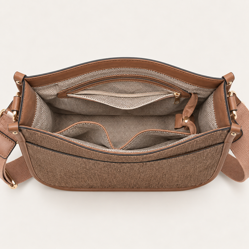 Open brown denim crossbody bag showing organized interior compartments and zip pocket