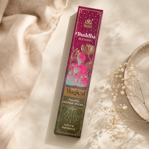 A boxed incense stick package labeled Buddha Blessing and Magical Forces, photographed on a warm cream surface with draped fabric, dried flowers, and a ceramic plate nearby.