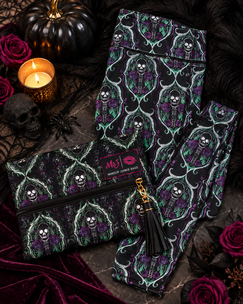 A gothic-themed clothing set featuring a black and purple skeleton rose pattern, styled in a Halloween flat-lay with a matching zip pouch, black tassel zipper pull, and a pink 'My J' brand label.