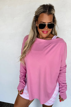 Mauvy pink athleisure top styled off the shoulder with casual shorts.